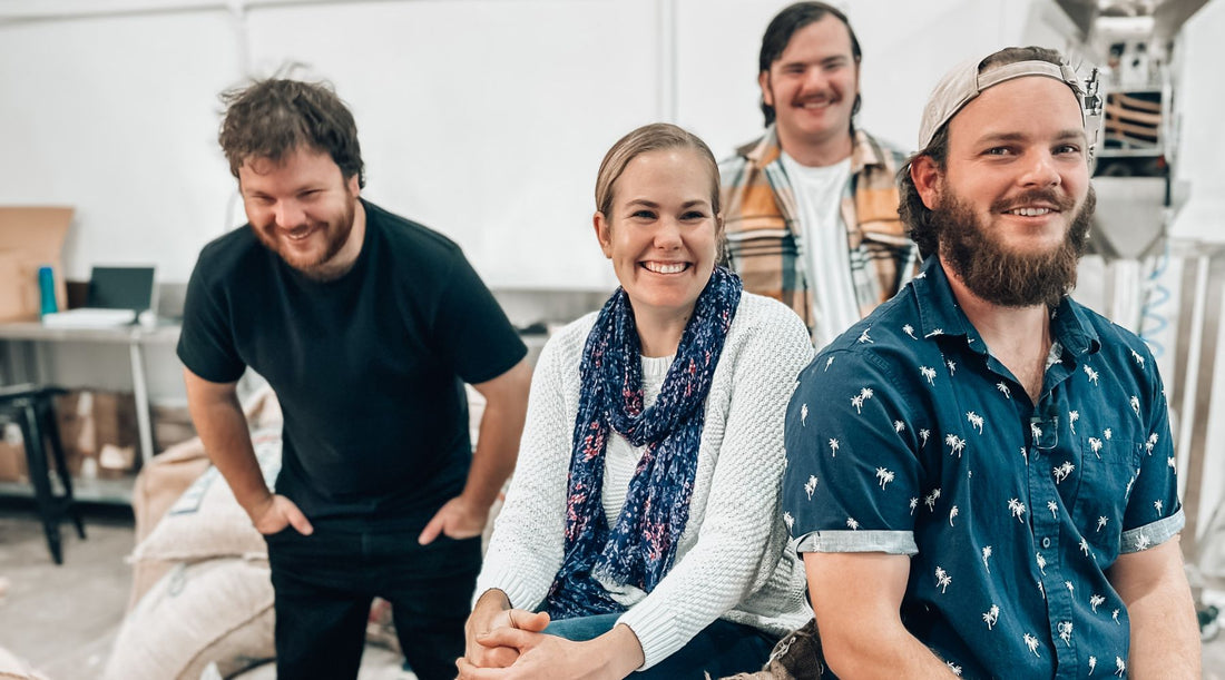 Perth -Coffee -Roaster - Brightside- Coffee- and -their -team- sitting- on- coffee- beans