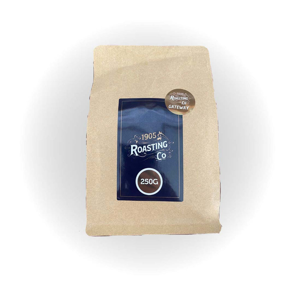 A bag of Perth Coffee Exchange coffee labeled "1905 Roasting Co.", 250g, with a dark blue label on a brown paper package, isolated on a white background.