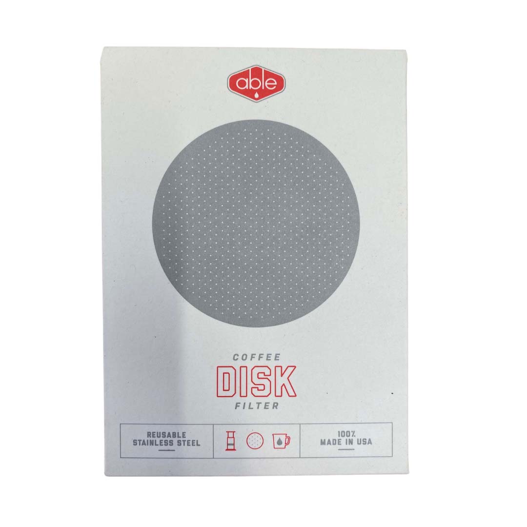A packaging of a reusable stainless steel coffee disk filter by able, labeled "Made in Usa," displayed against a plain background.