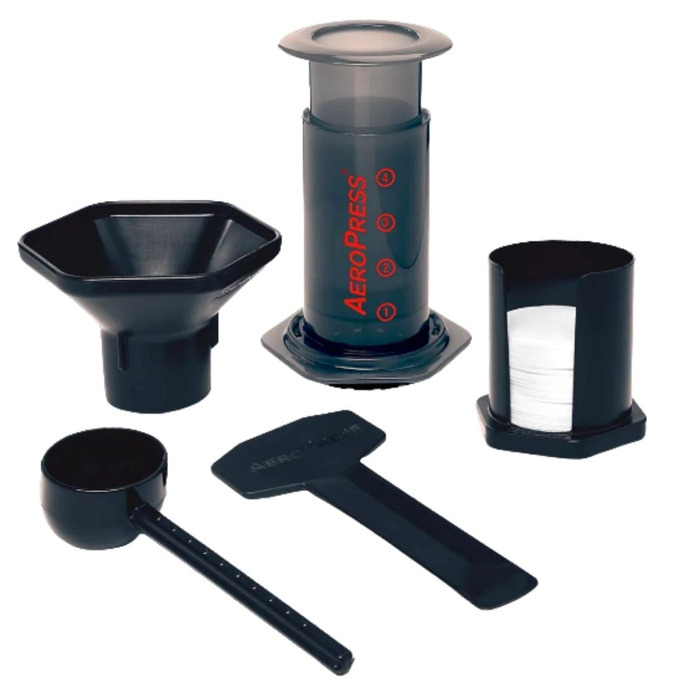 Perth Aeropress coffee maker set on a white background, including a coffee press, a funnel, a stirrer, a scoop, and a holder with a paper filter.