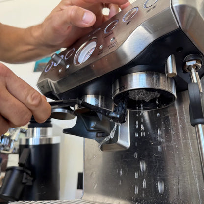 Group head brush in use on Breville Barista Express